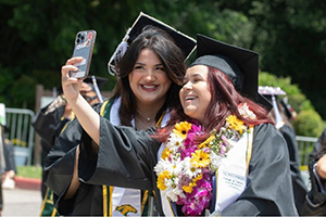 2 graduates taking selfies