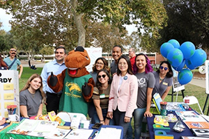 A group of students and professor standing with Billy Bronco (Mascot)