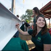 Collins Student Signing the Beam