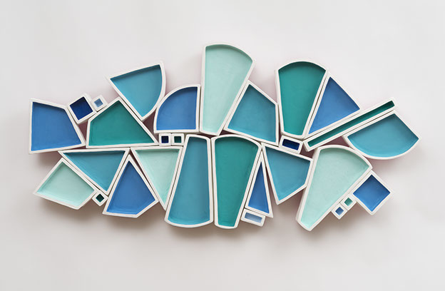 Alexis Kaminsky, Ice Flow, 2019. Ceramic, MDF, casein and spray paint, hardware. 16 x 33 x 2.5" Courtesy of the artist. A sculpture of geometric shaped objects placed together.