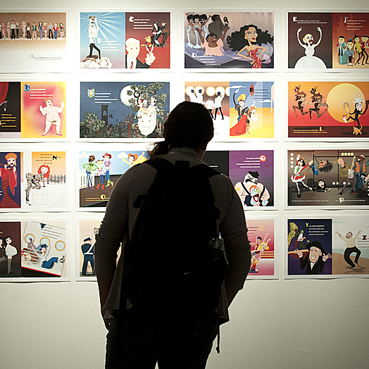 silhouette of person standing in front of posters in gallery space