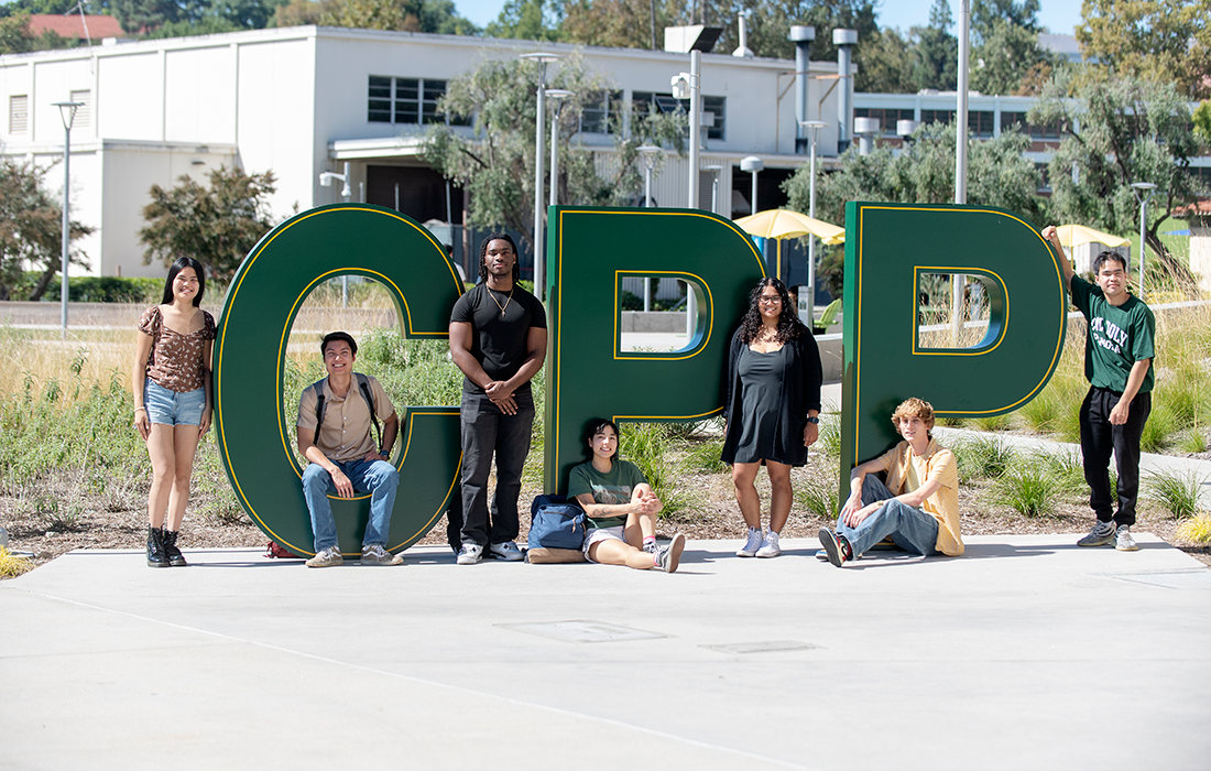 A group of students pose with the CPP Letters on campus. 