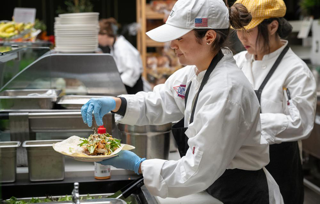 Student prepares a wrap during lunch at CenterPointe