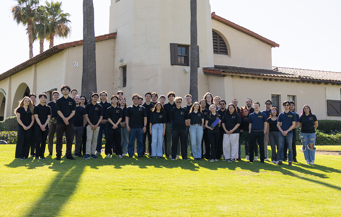 CubeStep Students group photo in front of the old stables on campus. 