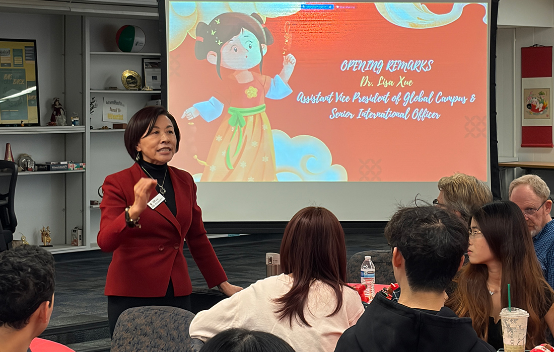 Lisa Xue speaks in front of an audience