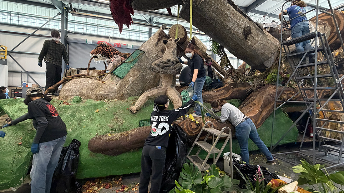 A group of CPP Students work on dismantling the Jungle Jumpstart rose float. 