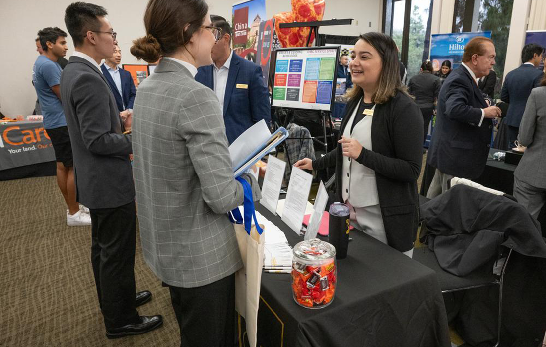 Columbia staff speak with a student at the Hospitality Expo