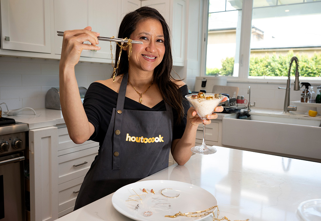 Sonia How holds up Jewlery in one hand and a martini glass with dessert in another. 