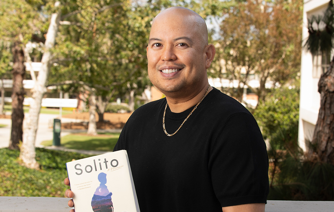 Anthony Ocampo holding the Solito: A Memoir book