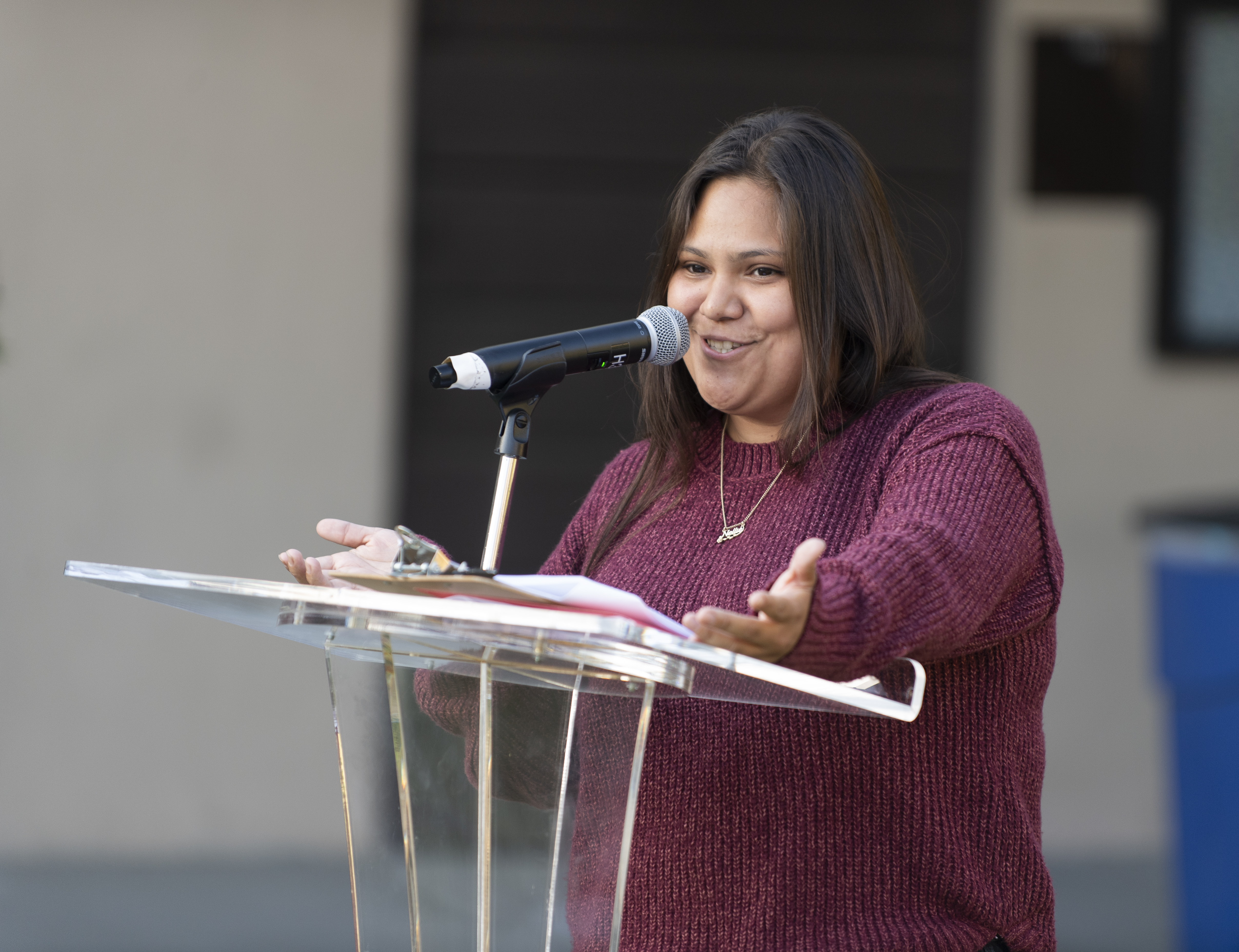 A female native american grad speaks during commencement ceremonies. 