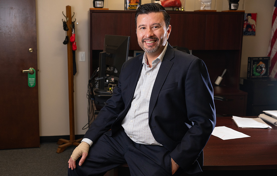 Louie Ruiz sitting on his desk