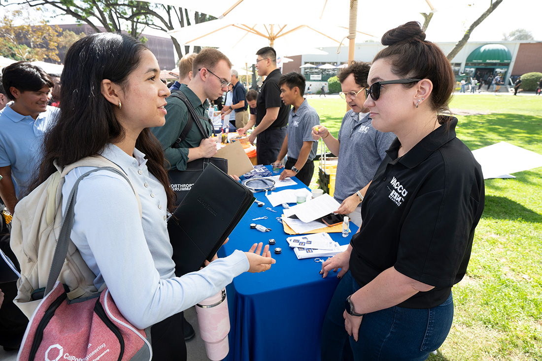 Students visit tables during a Career Center job fair event.