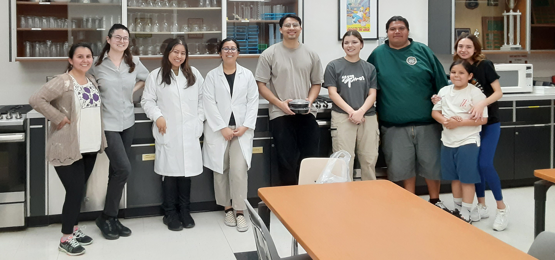 A group of students and family or community members in one of the labs