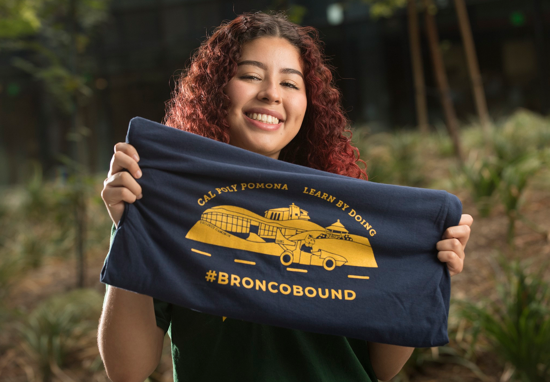 Student holding a BroncoBound shirt