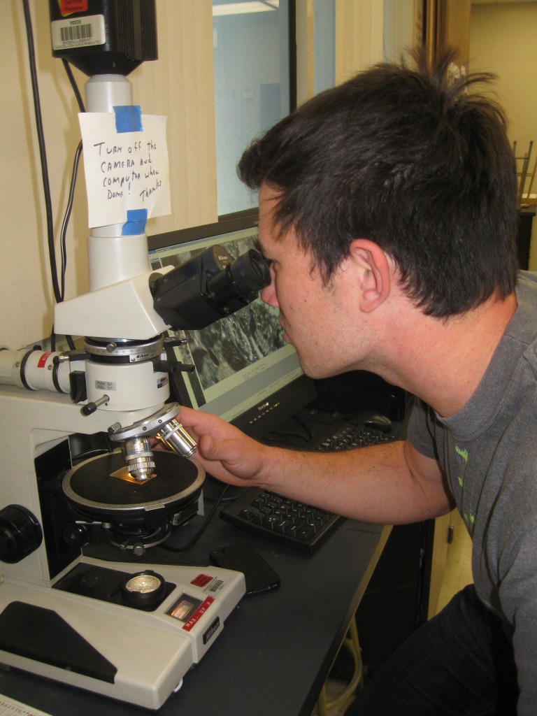 Andrew Barnhart using microscope
