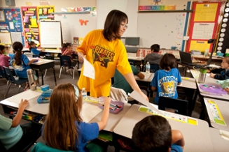 A female student teaching a class of elementary school students