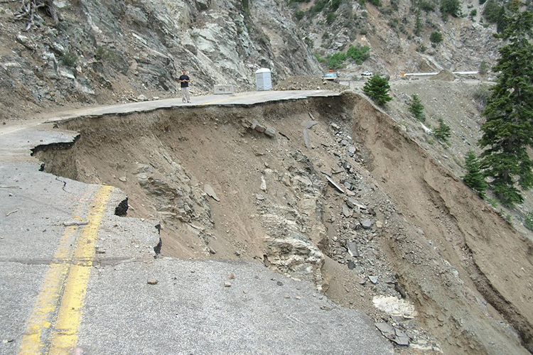 damaged road on the side of a mountain
