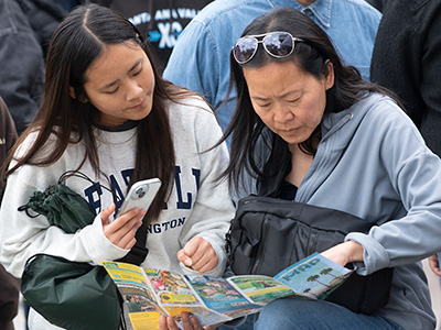 A mother and daughter look through a campus map during Broncobound