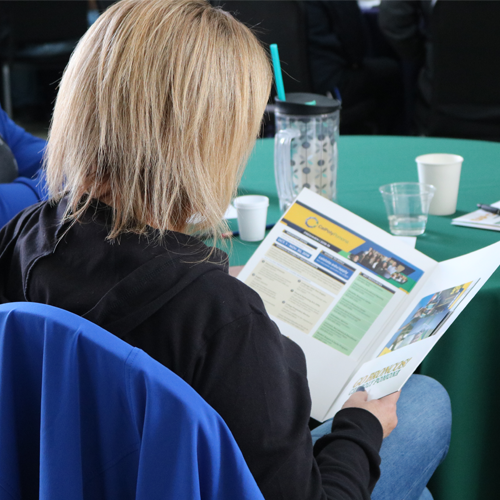 Image of a woman reading an informational brochure.
