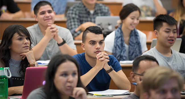 Students sit in a classroom listening to a lecture