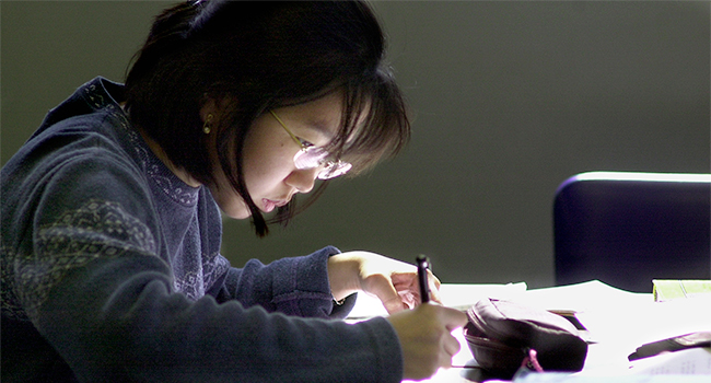 A female student studies for finals