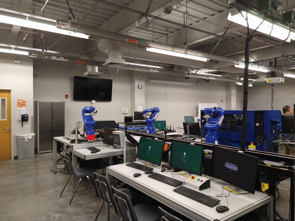 Automation lab with robotic systems and computer workstations.