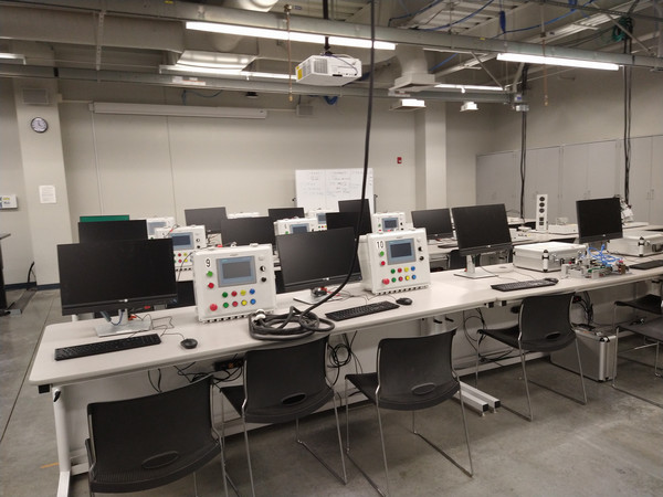 Automation lab with control panels, computer monitors, and student workstations used for hands-on instruction.