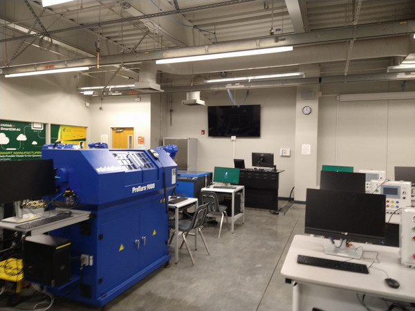 Automation lab with advanced manufacturing equipment, computer workstations, and instructional technology.
