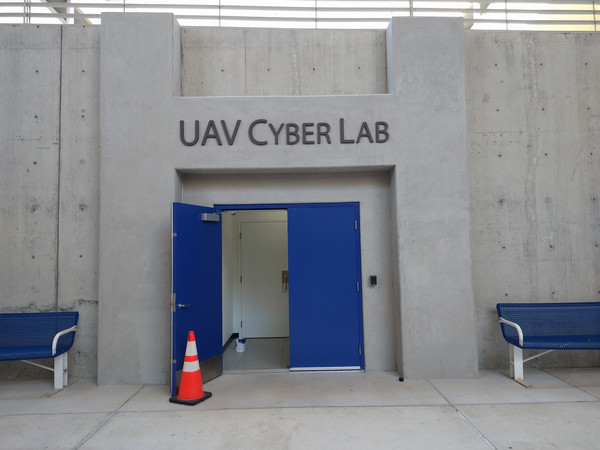 Entrance to the UAV Cyber Lab in Building 98 with blue double doors and lab signage above.