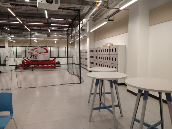 Interior of the UAV Cyber Lab with a secured drone testing area, worktables, and open lab space in Building 98.