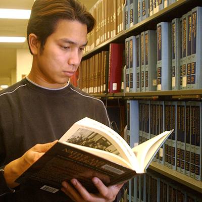 Student looking through book