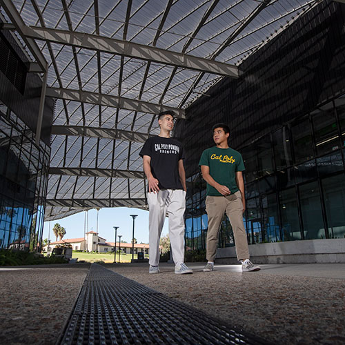 Two students walking through the breezeway between the Student Service buildings