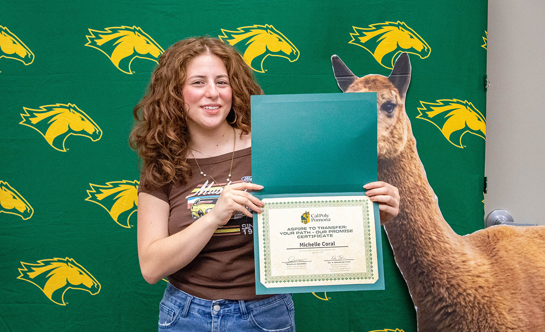Student parent holding an admission certificate and her child