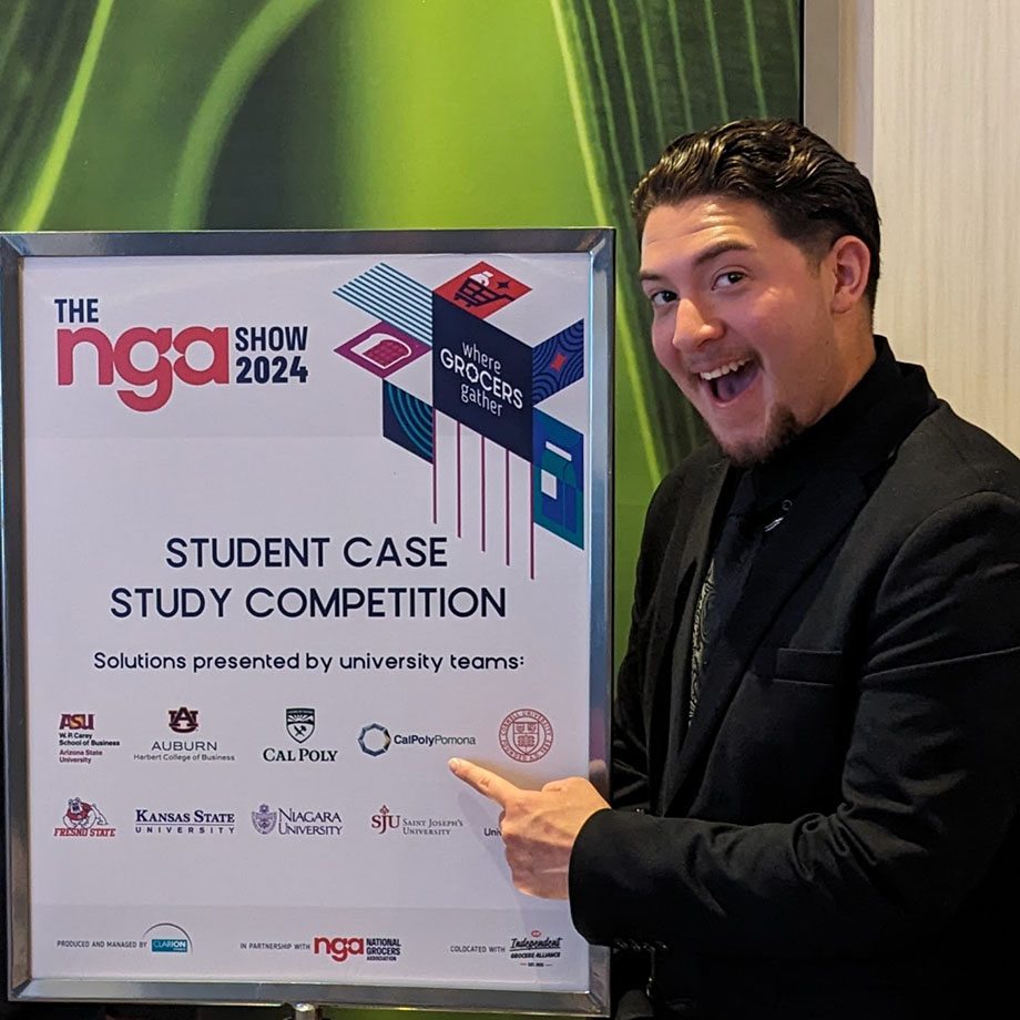 A student gestures at a sign at competition.