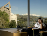 student reads document in library