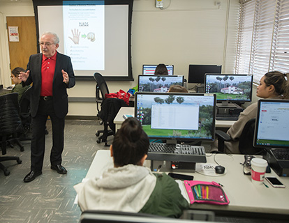 A guest speaker talks to students in one of the AMM computer labs.