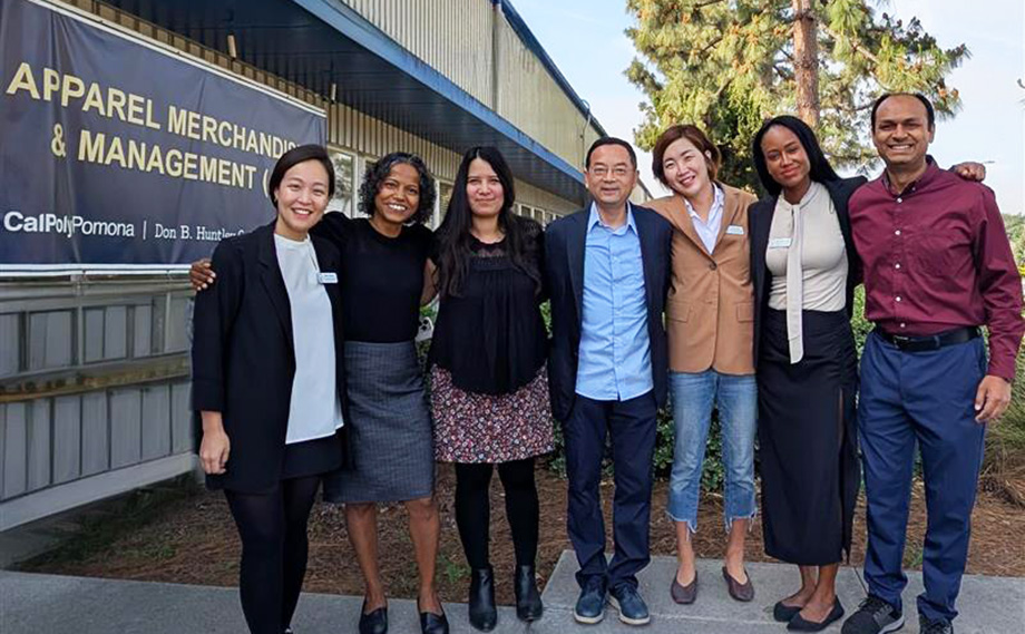 Tenure-track faculty pose for a photo outside Building 45.