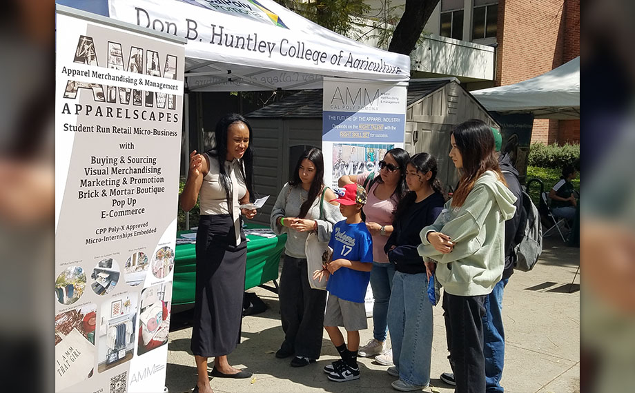 A family stop by the AMM booth at open house