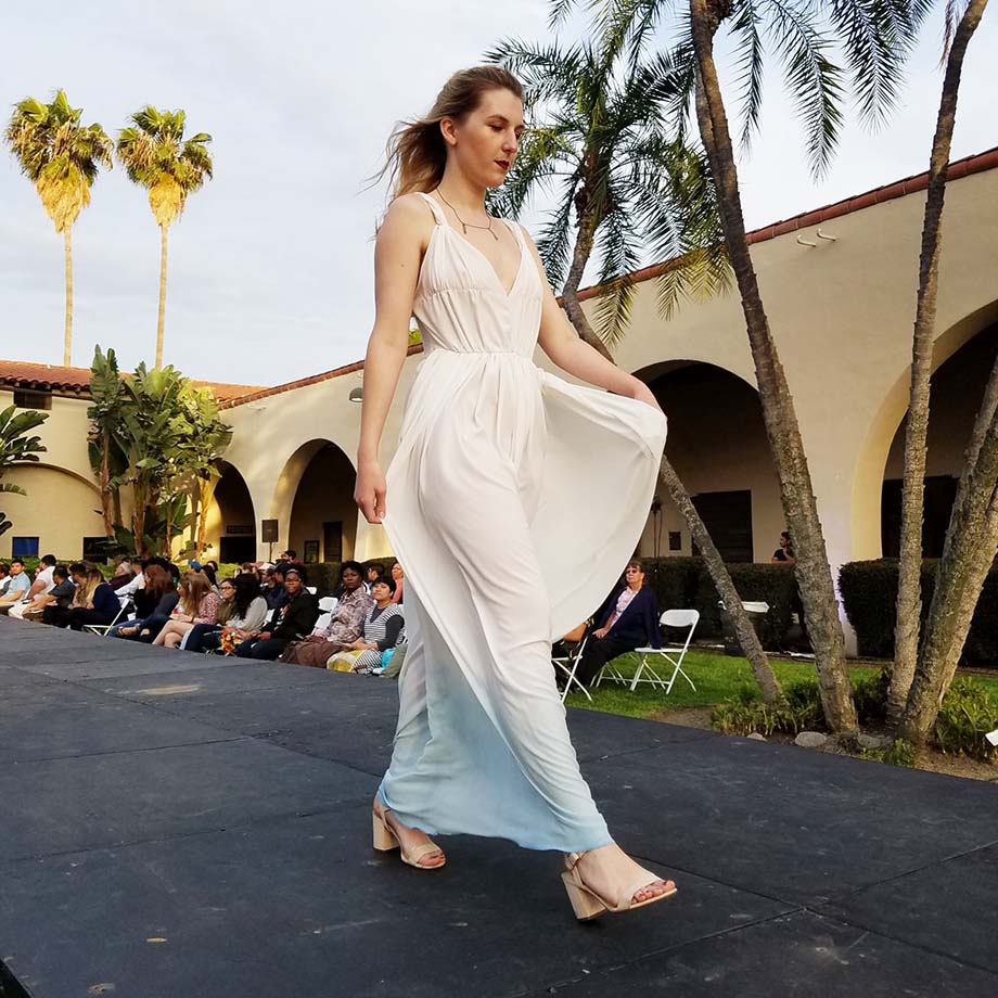 A female model walks the runway at a fashion show on the Cal Poly Pomona campus.