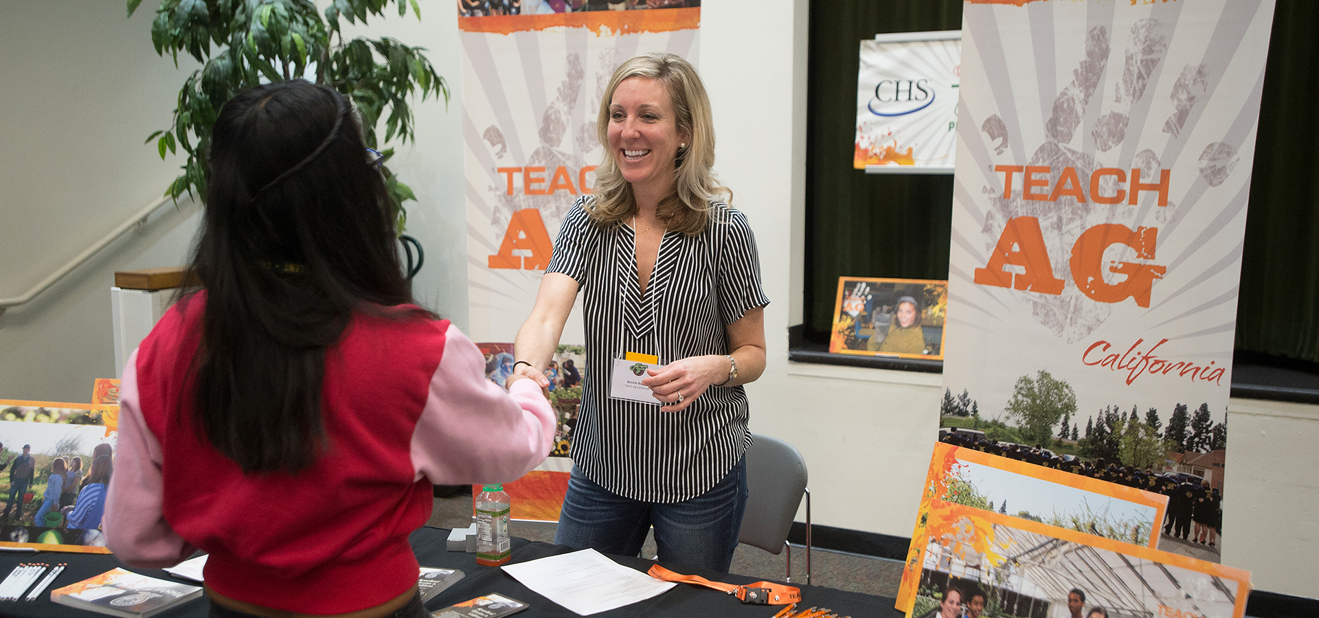 A employer representative greets a student at the 2018 Ag Career Day