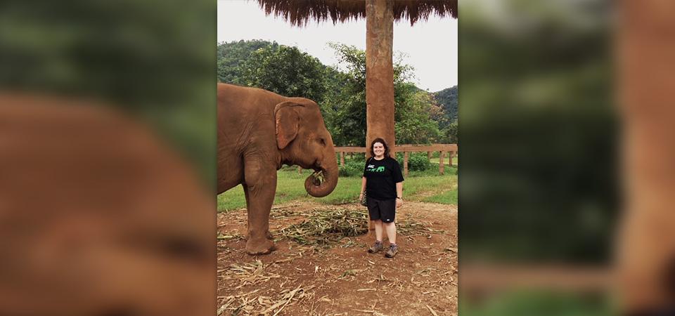 Julia Feldman poses with one of the elephants she worked with in Thailand.