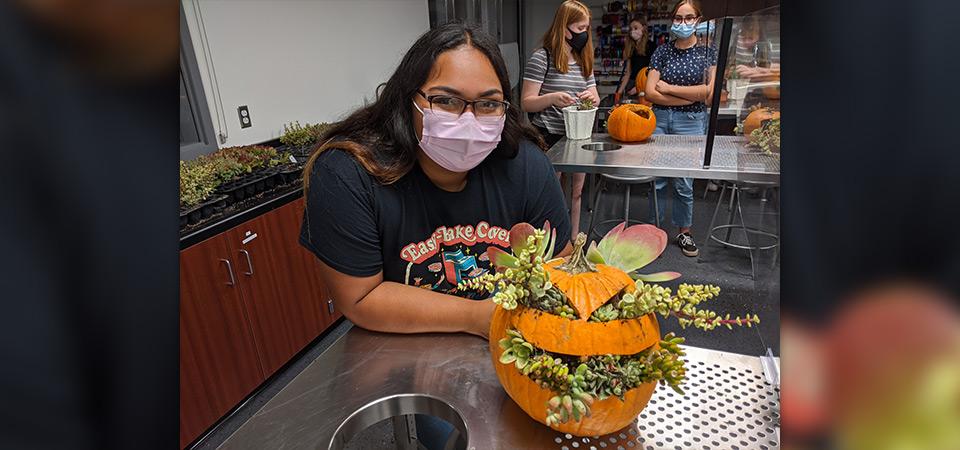 A Make and Take class participant with her pumpkin