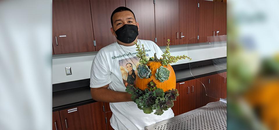 A Make and Take class participant with his decorated pumpkin.