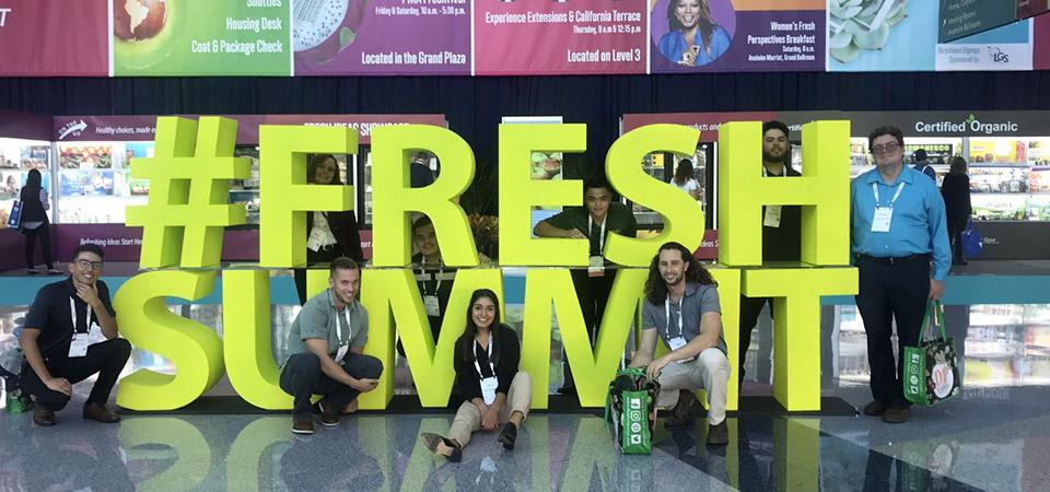Cal Poly Pomona students pose by a #FreshSummit sign at the conference.