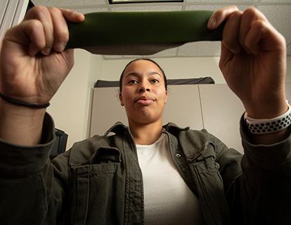 A student holds up cactus leather.