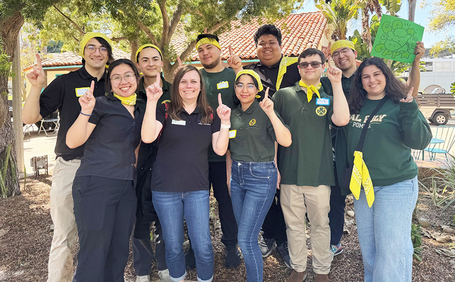 Students and their advisor celebrate after winning a competition.