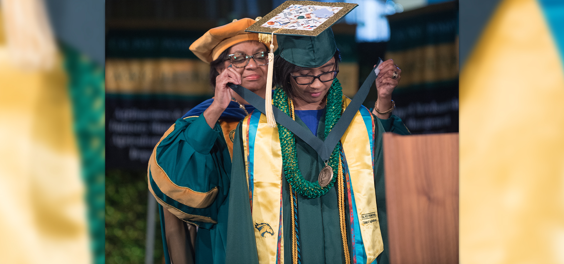 Cal Poly Pomona President Soraya Coley bestows a medallion upon a student at commencement.