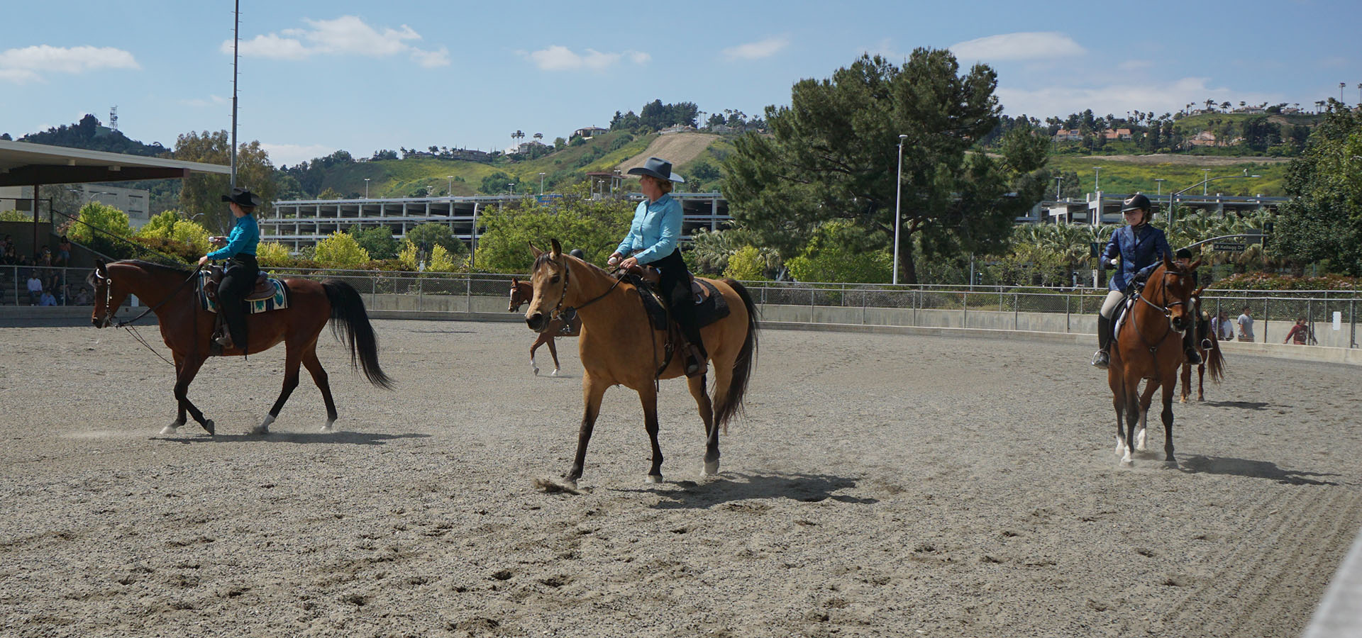 A trio of riders on horseback during a Sunday Horse Show performance