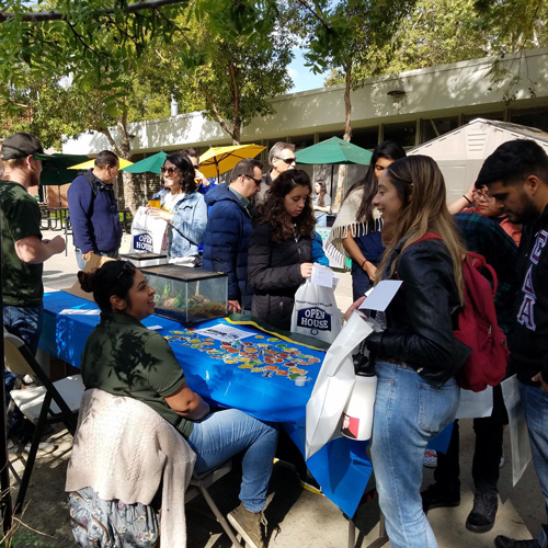 Students visit an agriculture kiosk at an event