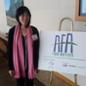 Irene Ngo poses by an Agriculture Future of America sign at the AFA Food Institute.